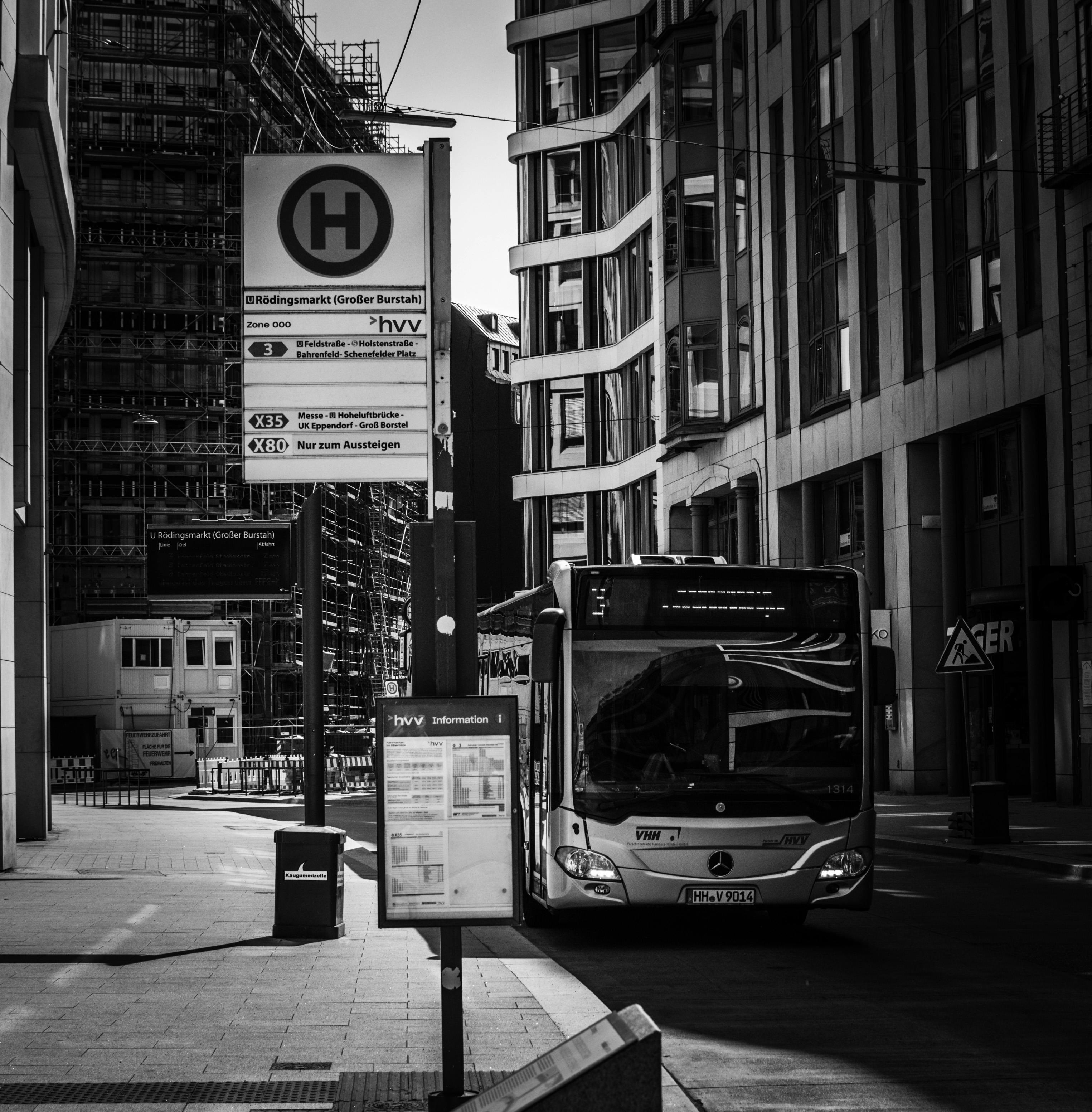 grayscale-photo-of-a-bus-near-a-building-free-stock-photo