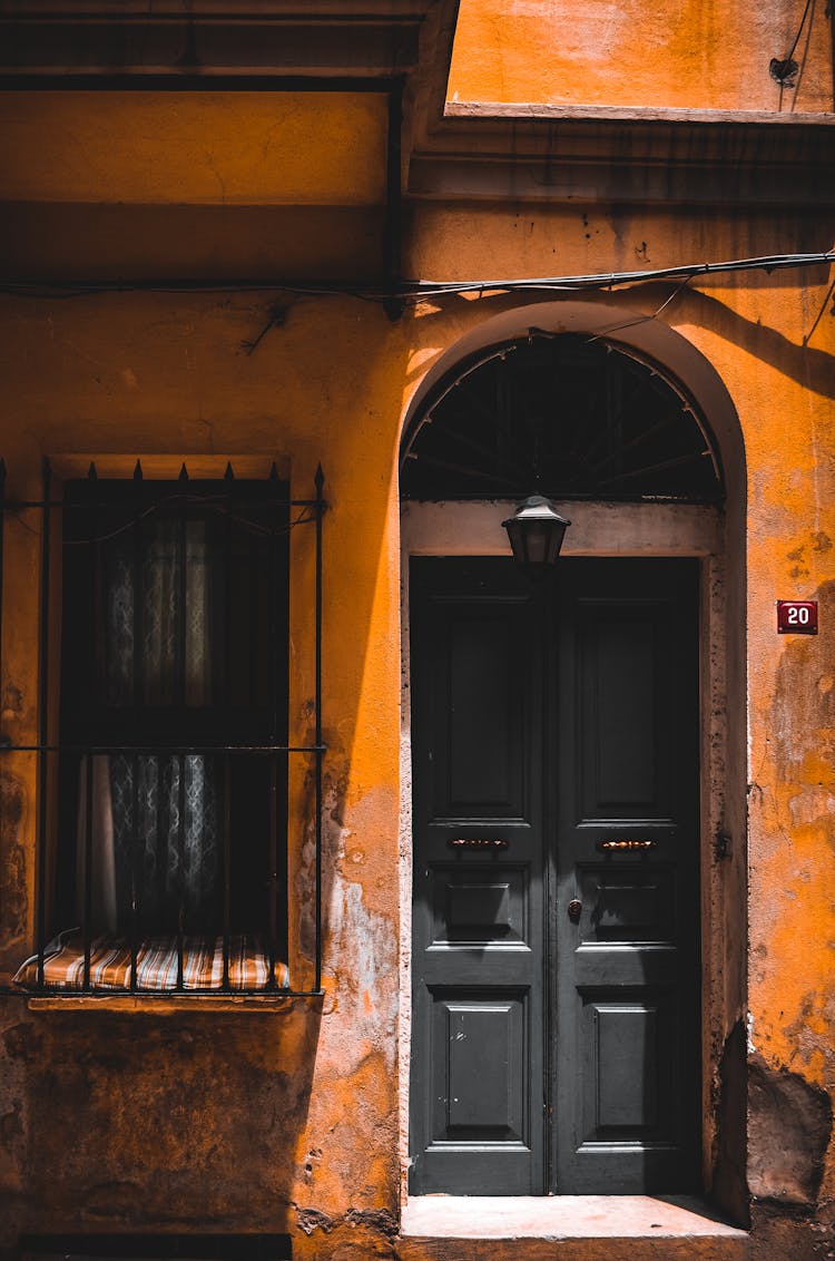 Photograph Of A Black Door Near A Window