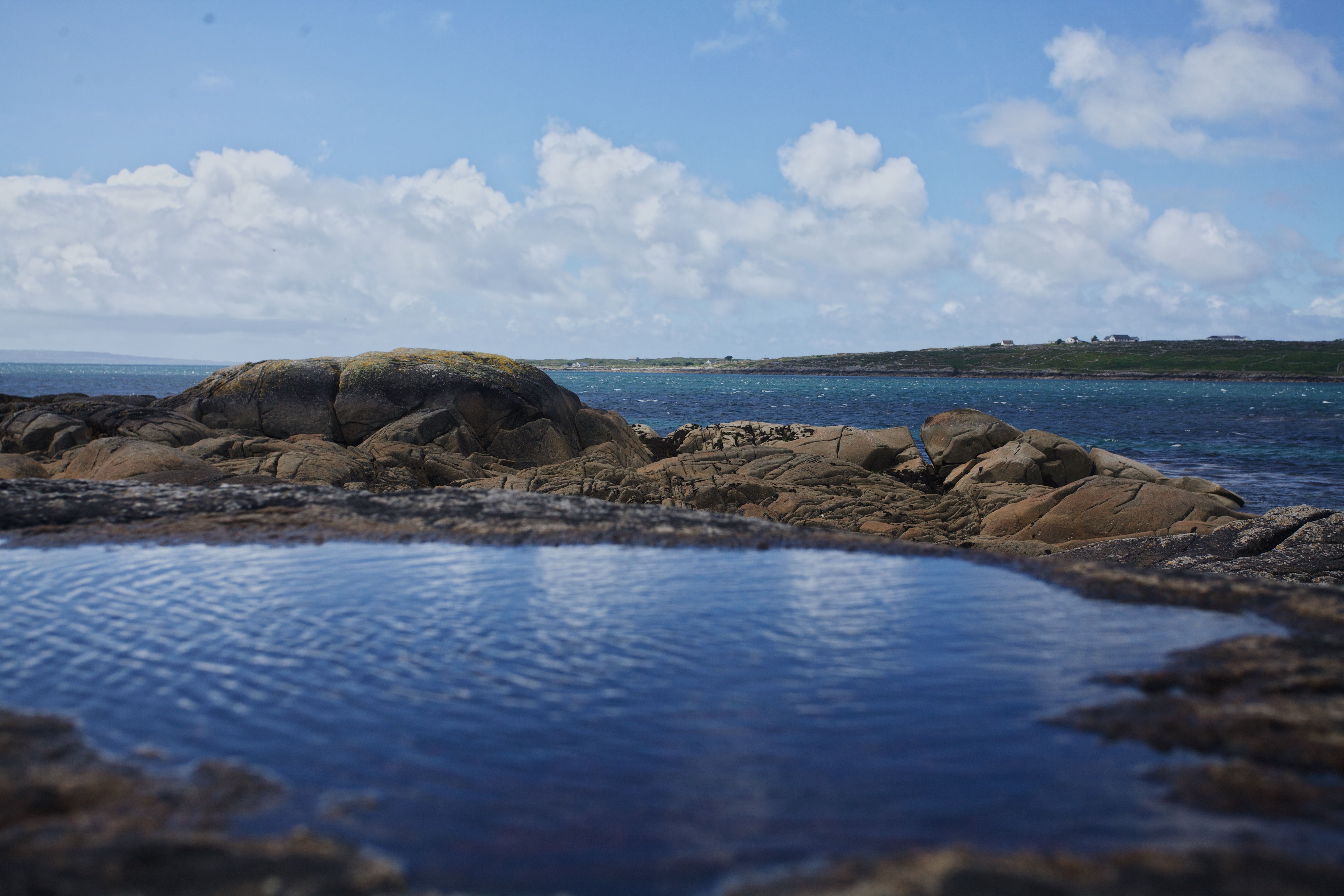 Photo of Brown Rocks Near a Blue Ocean · Free Stock Photo