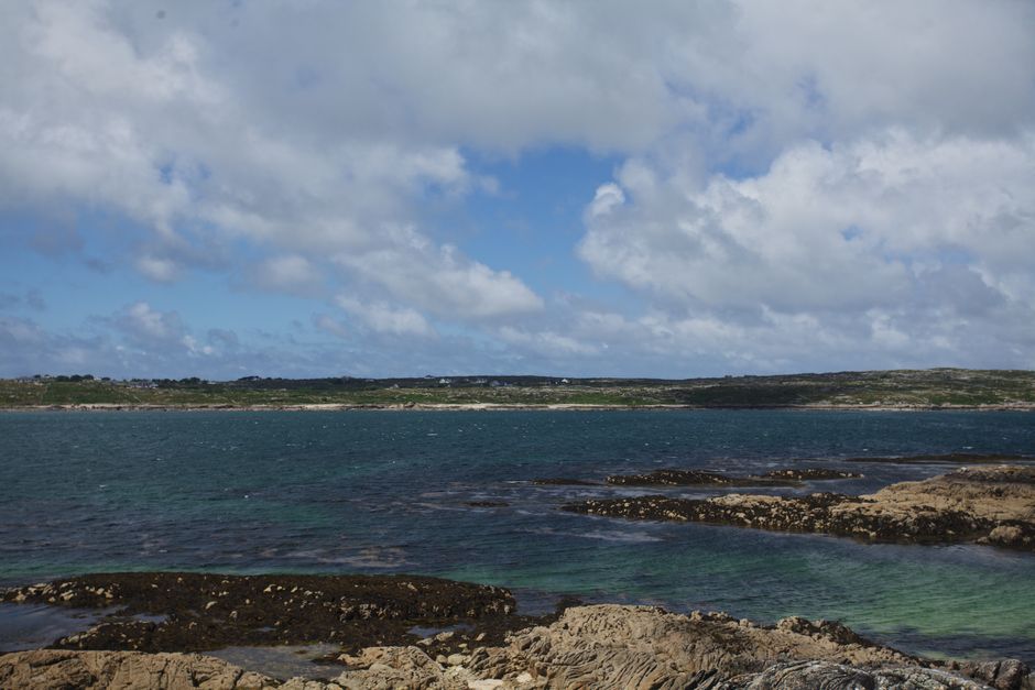 A picturesque view of Ireland A picturesque view of Ireland's rocky coastline with vibrant blue ocean and scattered clouds.