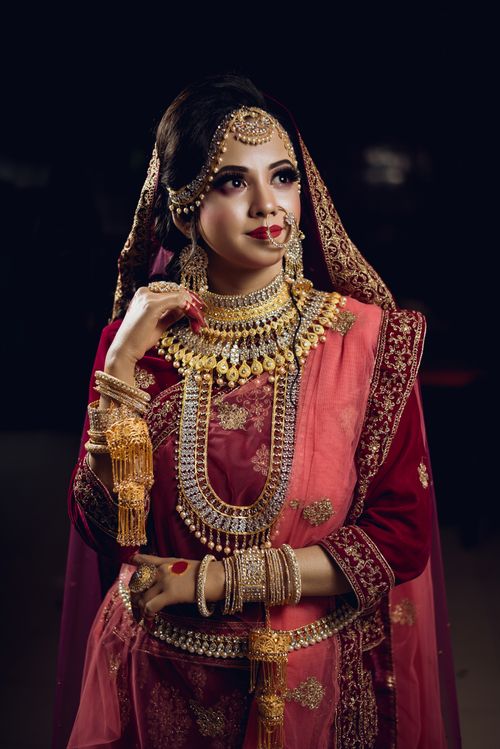 Free Elegant portrait of a South Asian woman in ornate bridal attire with intricate jewelry. Stock Photo