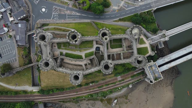 Drone shot of historic Conwy Castle with surrounding landscape in Wales.