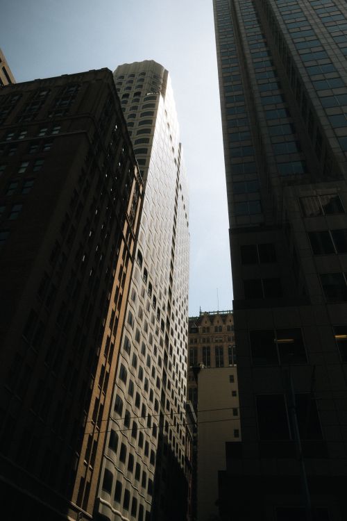 Free Dramatic view of urban skyscrapers reaching into a clear sky, capturing the essence of city life. Stock Photo