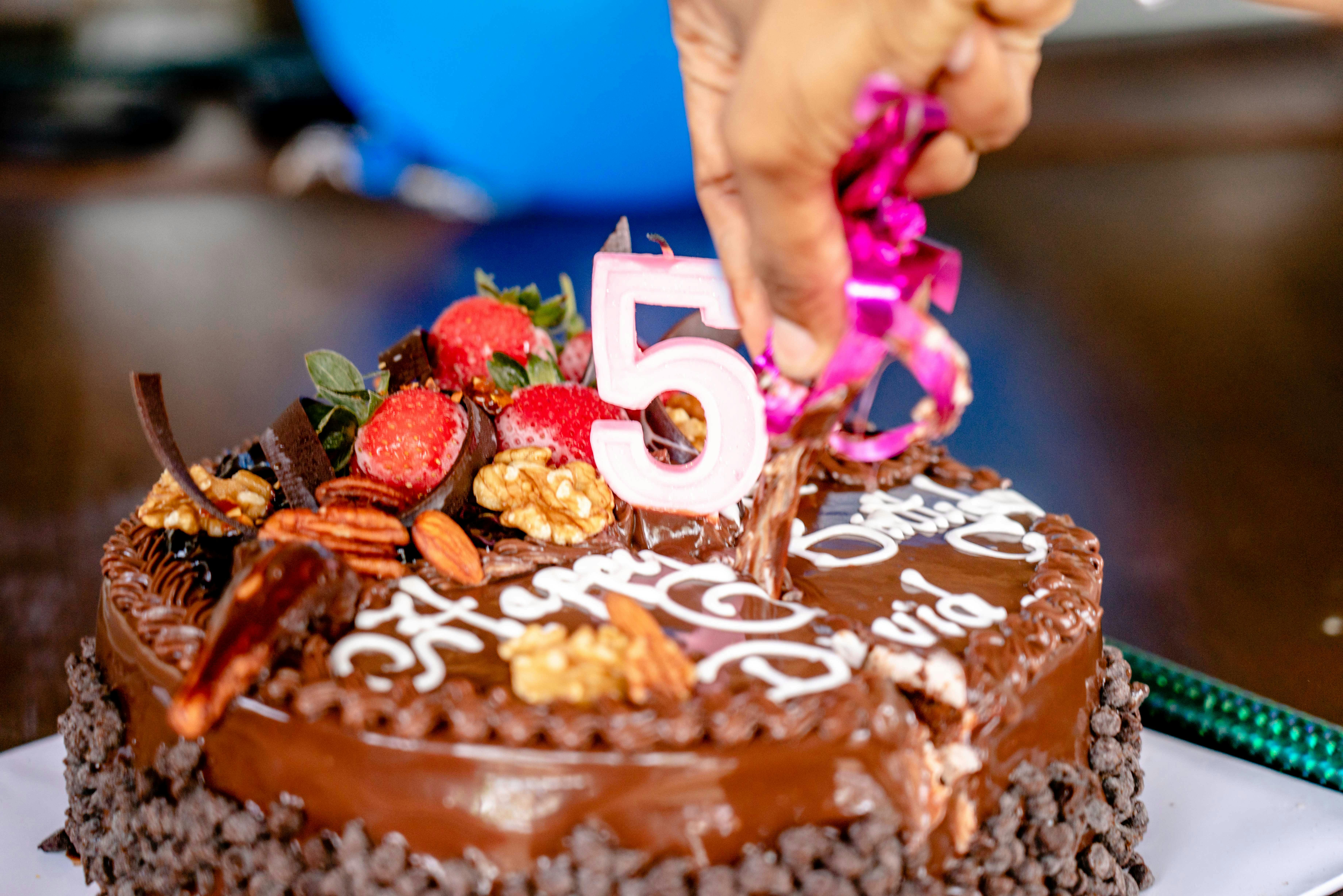 Close-up of a decorated chocolate cake for a 5th birthday celebration.