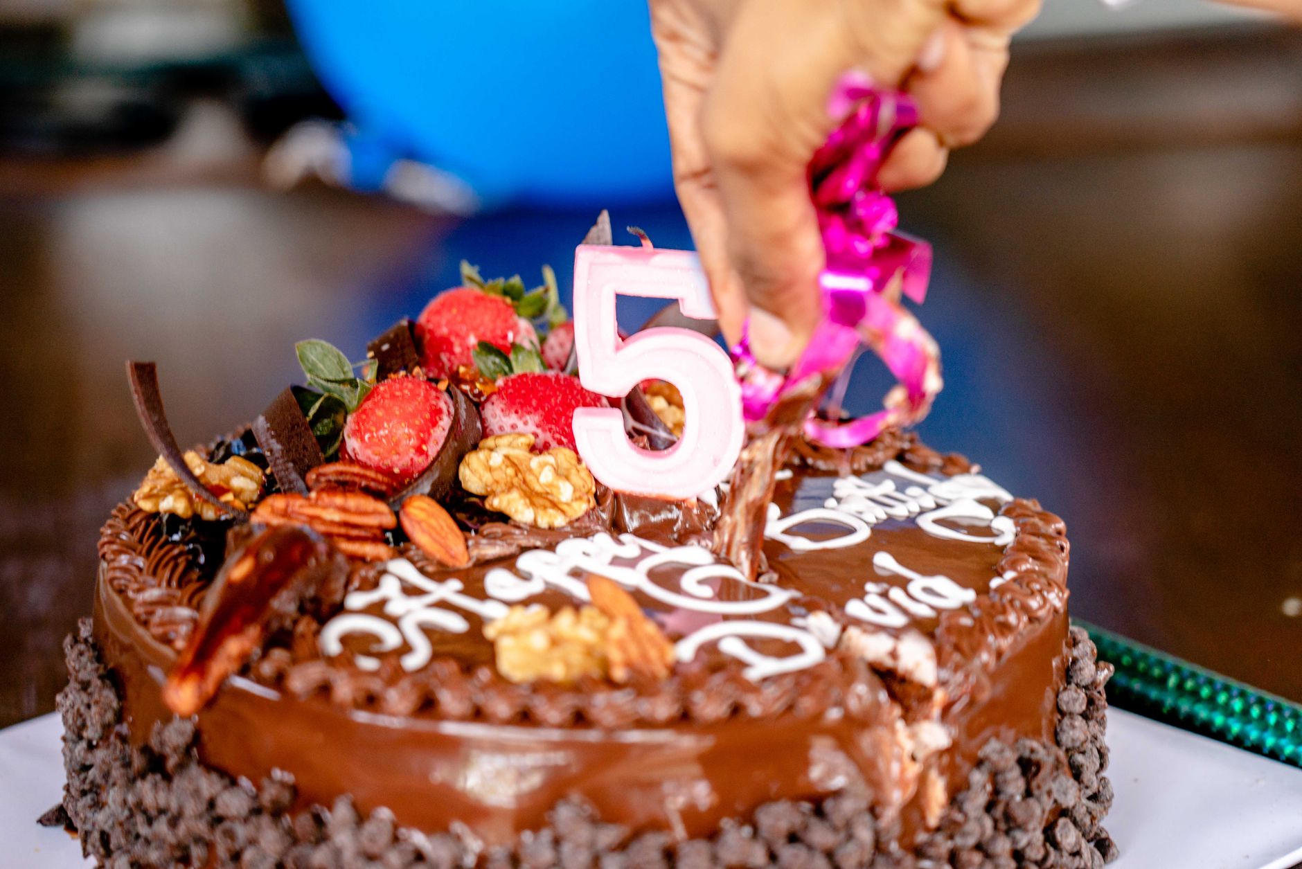 Close-up of a decorated chocolate cake for a 5th birthday celebration.