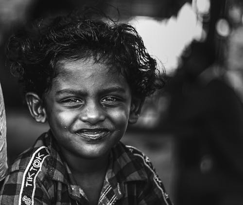 Grayscale Photo of a Smiling Boy