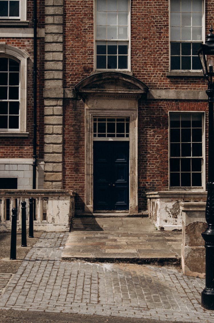 A Brick Building With Windows And A Door