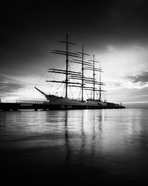 Grayscale Photo of a Ship on Sea