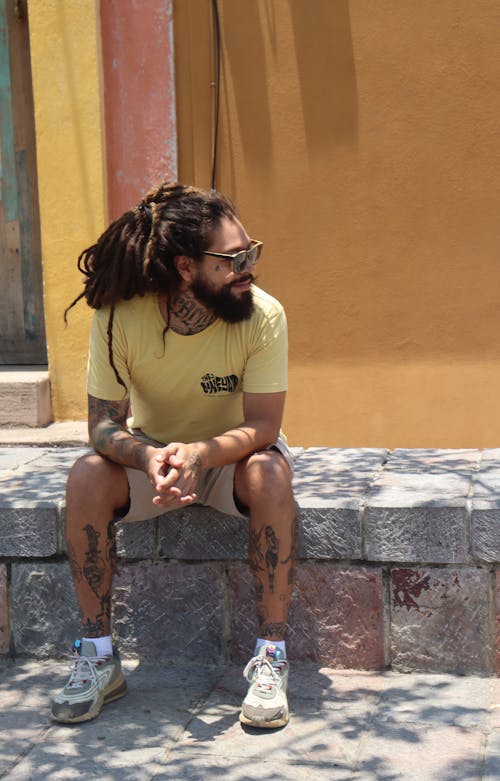 Photograph of a Man with Dreadlocks Sitting