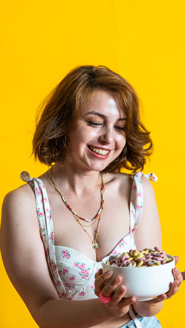 Smiling Woman Holding A Bowl Of Cereal