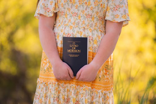 A Kid Holding a Mormon Book