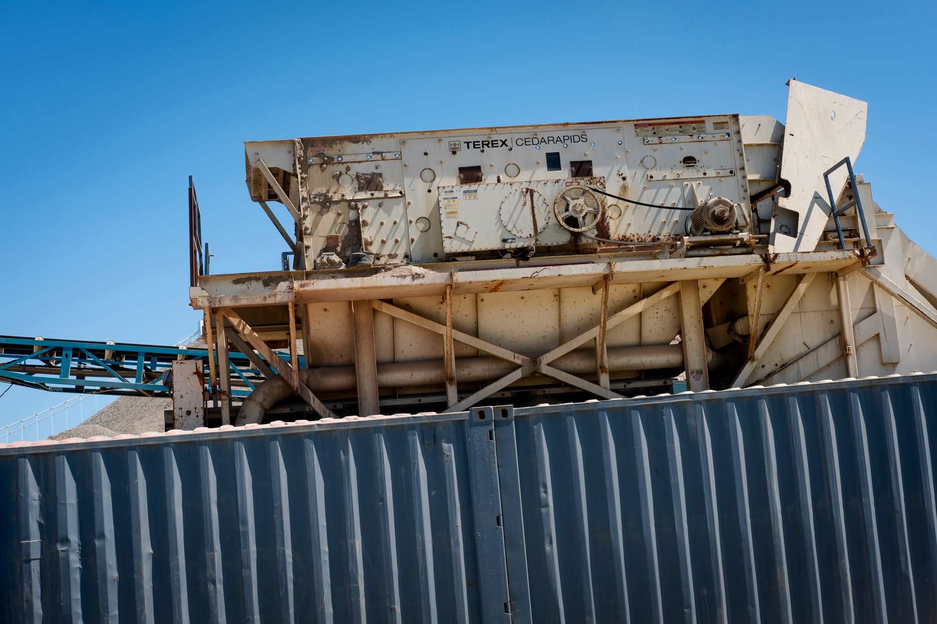 Close-up of large machinery under a clear blue sky, ideal for industrial themes.