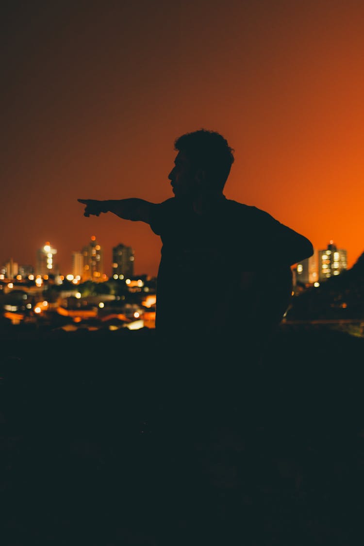 Silhouette Of Man Standing During Sunse
Silhouette Of A Man Pointing On City Building
