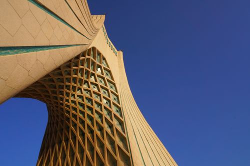 Free Low angle perspective of Azadi Tower in Tehran against a clear blue sky. Stock Photo