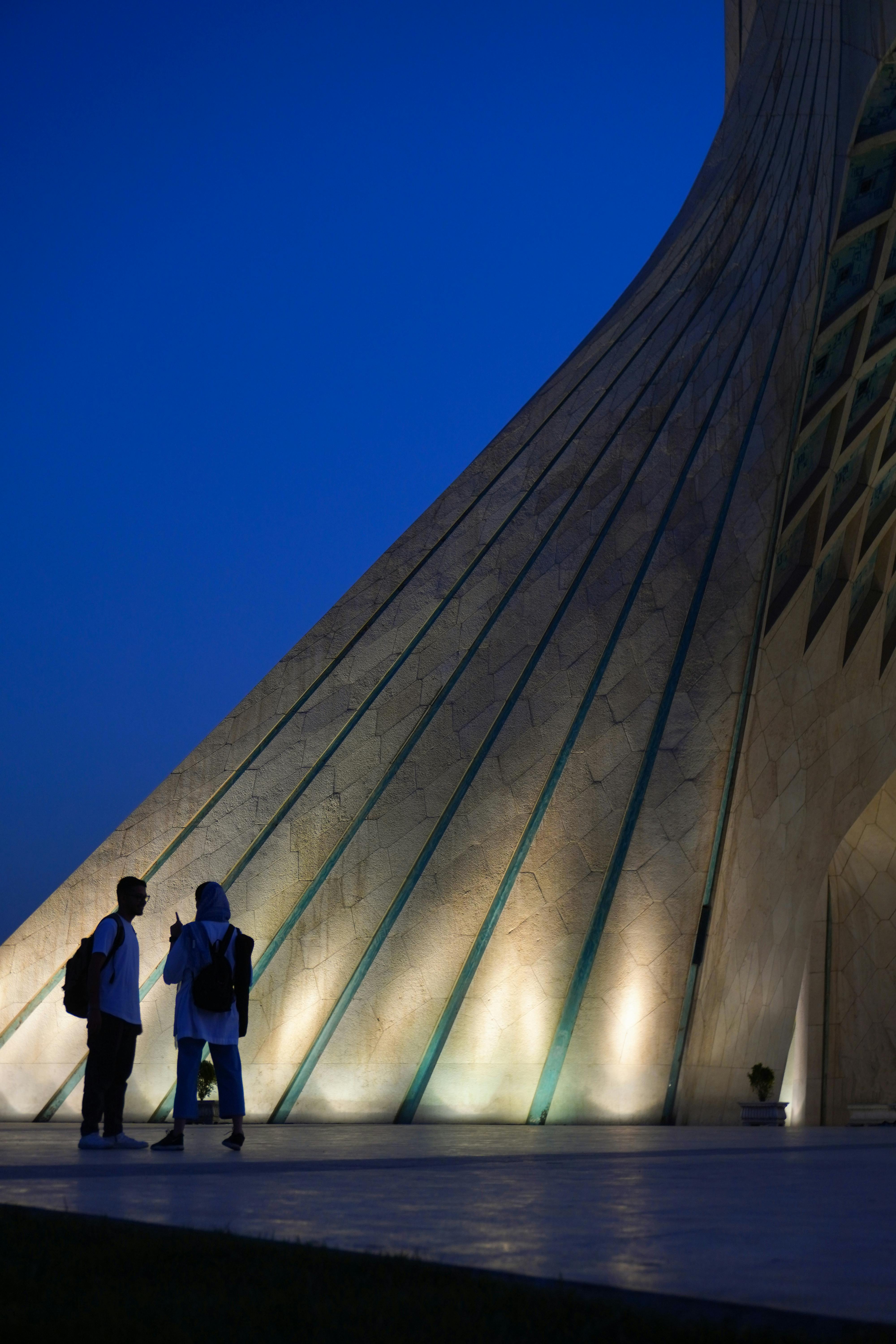 photo of people standing near the azadi tower