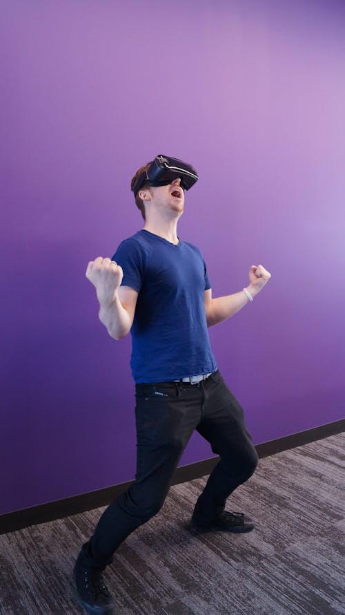 Free Man having Thrilling Experience Using VR Headset Stock Photo