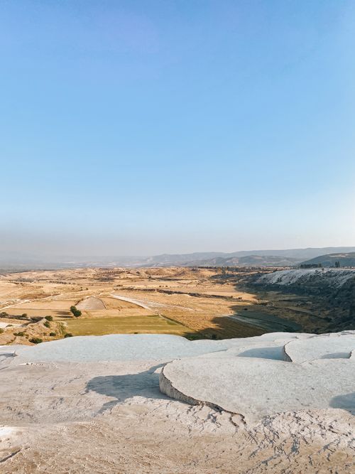 Free A breathtaking view of Pamukkale's travertine terraces under a clear blue sky. Stock Photo