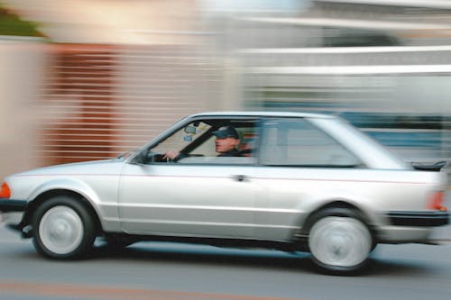 A Man Driving a Gray Car