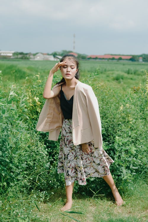 Woman Standing Barefoot on Grass