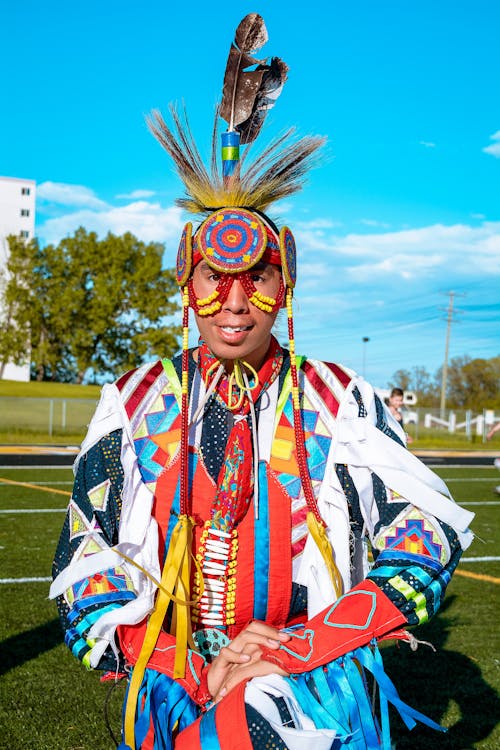 A Man in Traditional Wear Kneeling