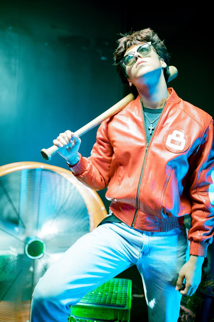 Person In Red Leather Jacket Holding A Bat