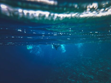 A person snorkeling underwater, exploring the vibrant sea life below the surface.