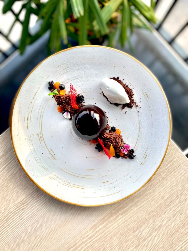 Beautifully plated gourmet dessert with chocolate and cream