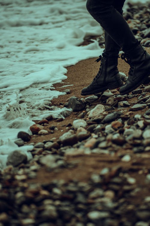 Photograph of a Person's Feet on Stones