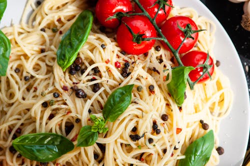 Close-Up Photo of a Plate with Pasta and Tomatoes