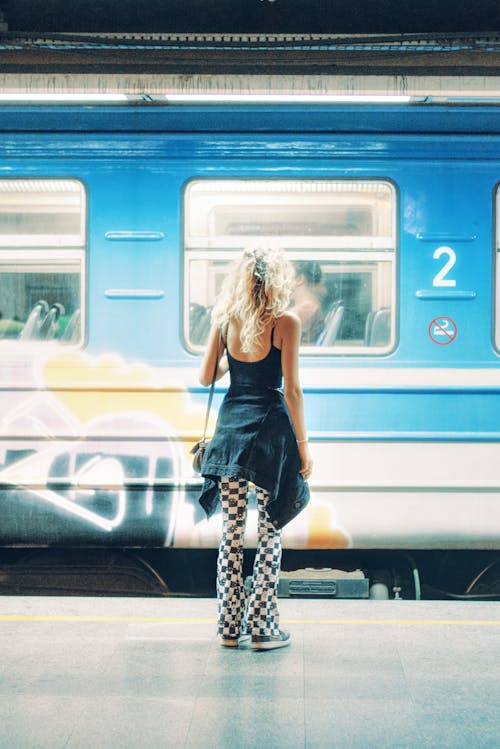 Back View of a Girl near a Train