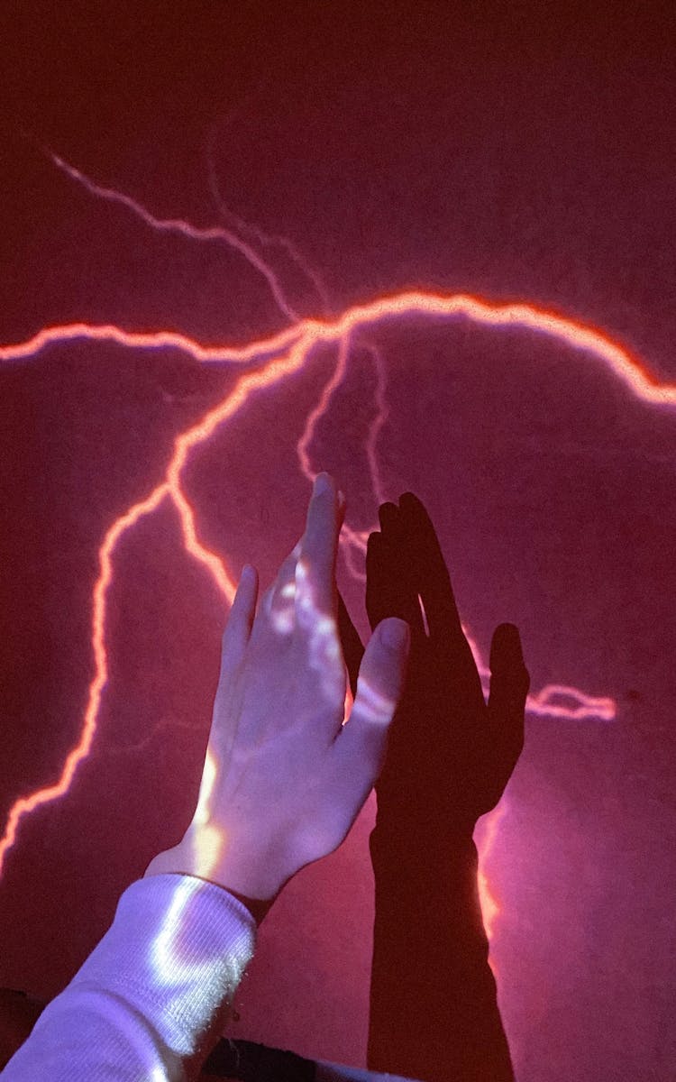 A Person Touching A Lightning On A Wall