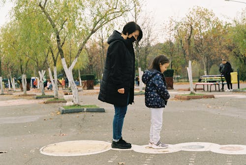 A Woman and Her Daughter Playing at a Park