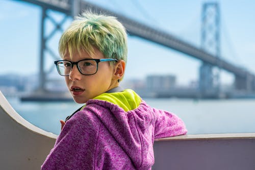 Selective Focus Of Boy Fronting Bridge