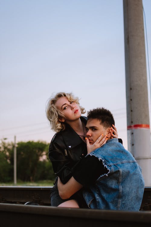 Free Woman in a Leather Jacket Hugging a Man Stock Photo