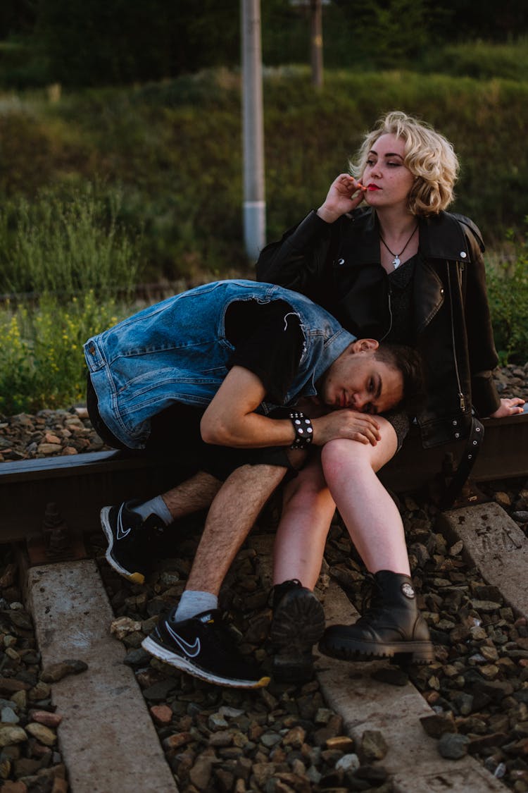 Punk Couple On Railroad Tracks