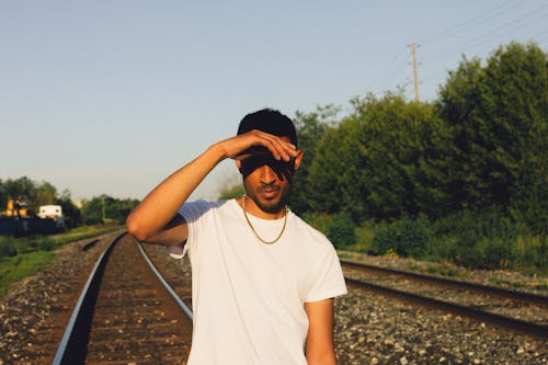 Man in White Crew Neck T-Shirt in a Train Track