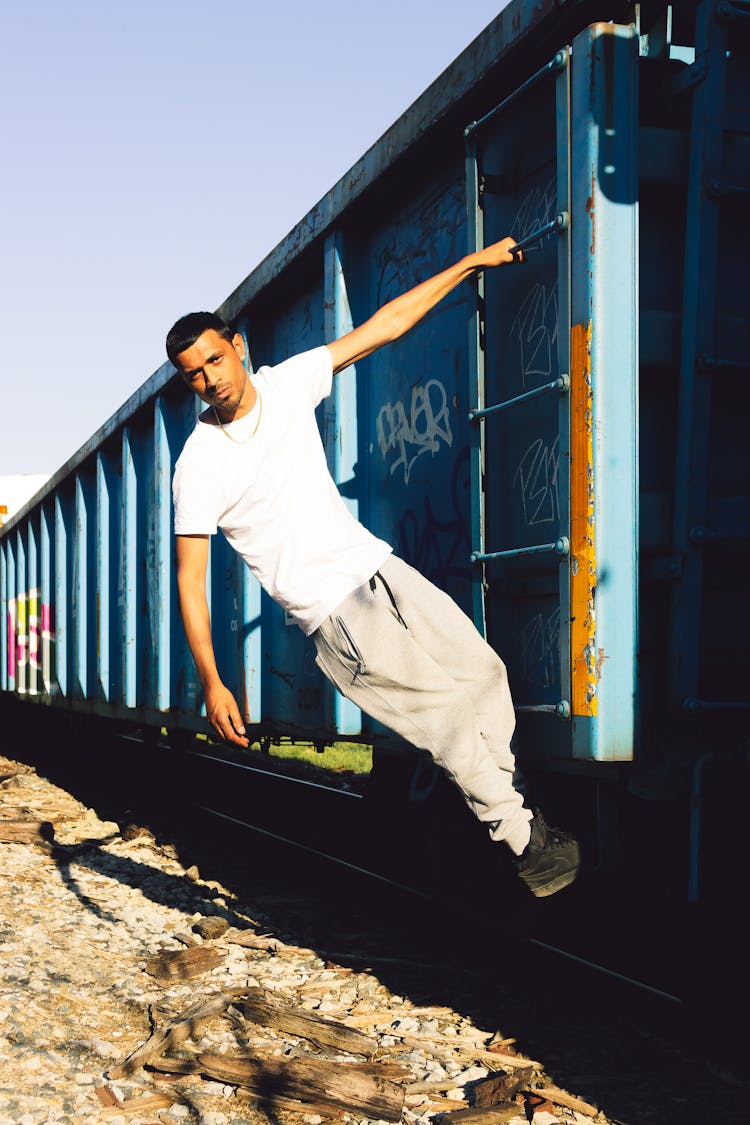 Portrait Of Man Hanging From Train Car