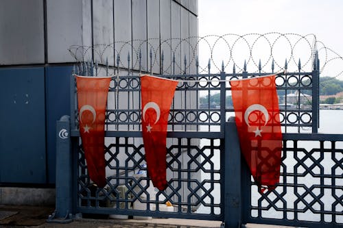 Turkish Flags Hanging on Metal Railing