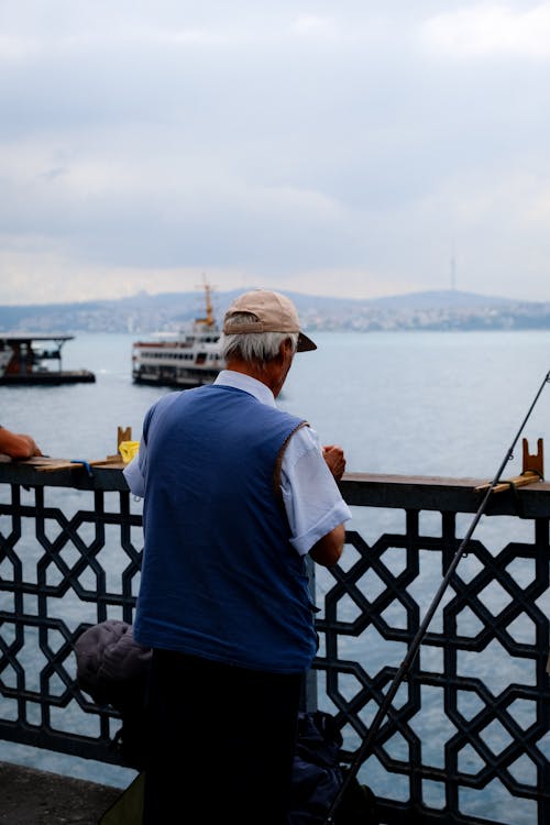 Man Looking at Water while Fishing