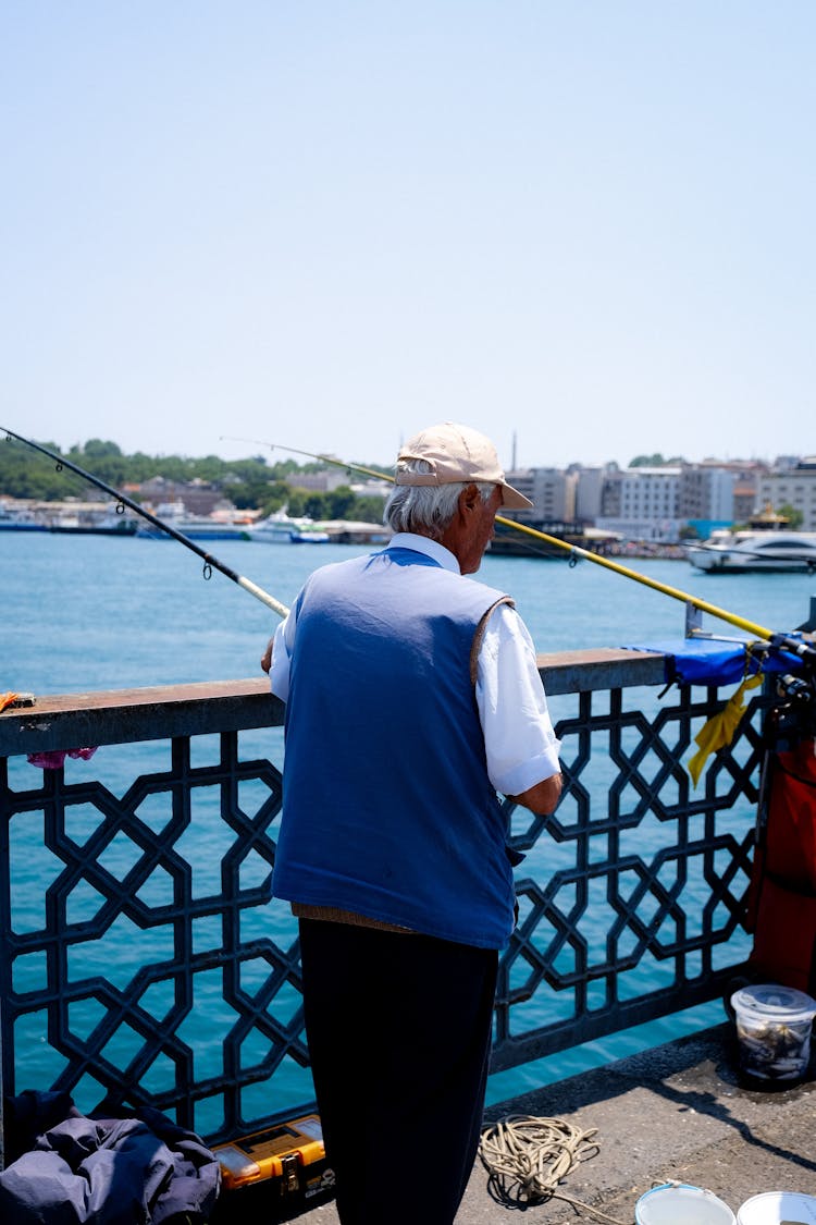 Elderly Man Fishing On The Pier