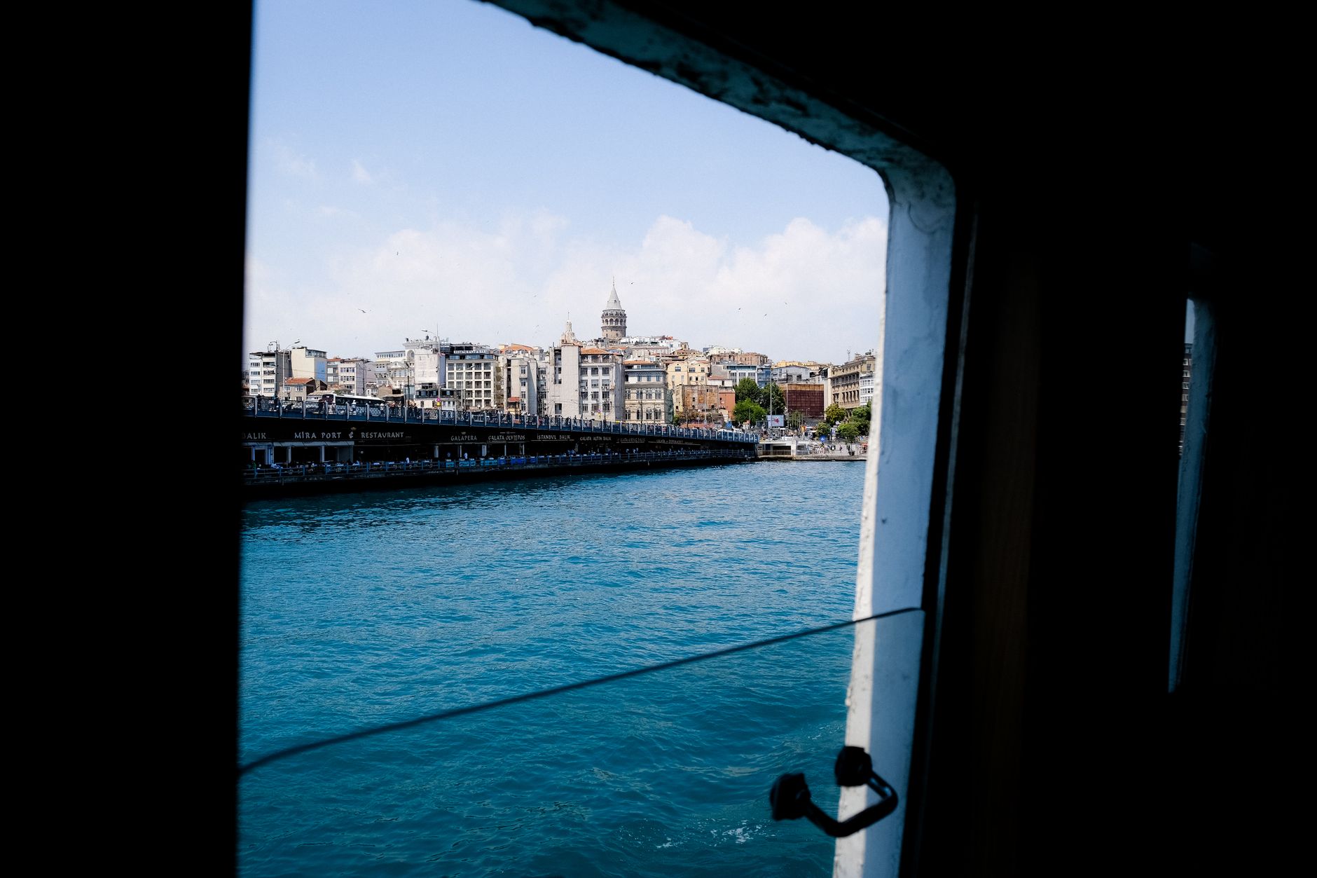 View of the Galata Tower and Istanbul skyline from a ferry on the Bosphorus.