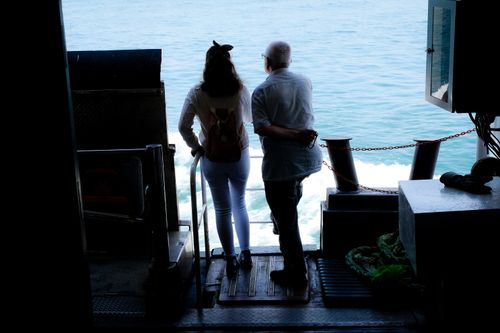 Free A couple enjoys a peaceful ferry ride with a view of the sea in Istanbul. Stock Photo