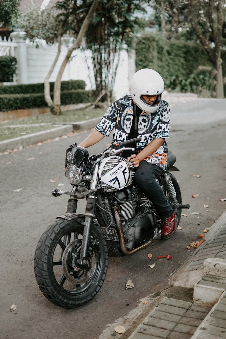 Man Wearing A White Helmet Riding A Motorcycle