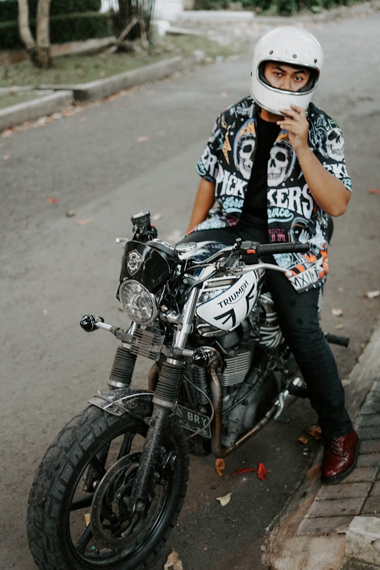 Man Wearing White Helmet Riding A Motorcycle