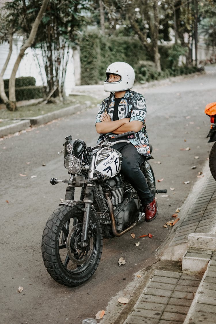 Man Wearing White Facemask Riding A Motorcycle