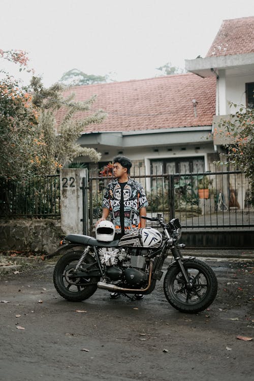 Portrait of Biker with Motorcycle on Street