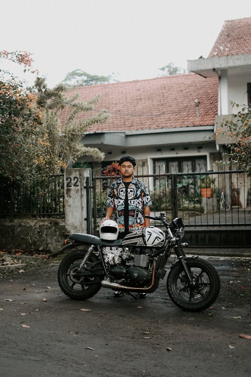 Portrait of Biker with Motorcycle on Street