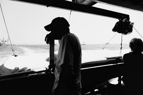 Black and White Photo of People on Fishing Boat