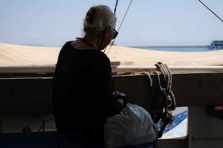 Silhouette Of A Senior Woman Sitting In A Boat