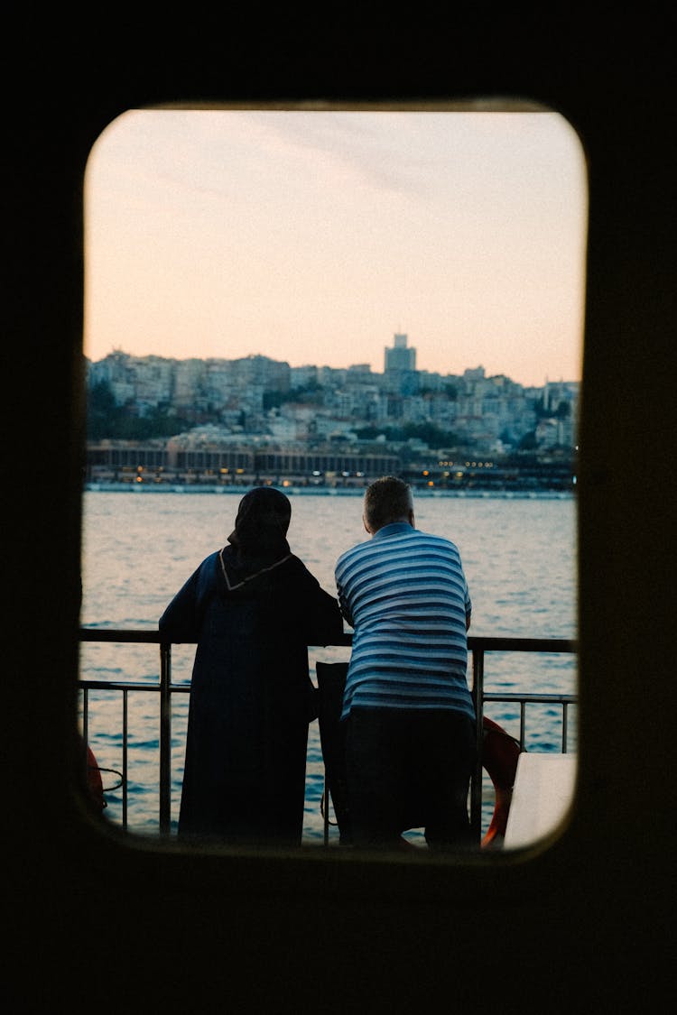 Couple On A Boat Looking At A View 